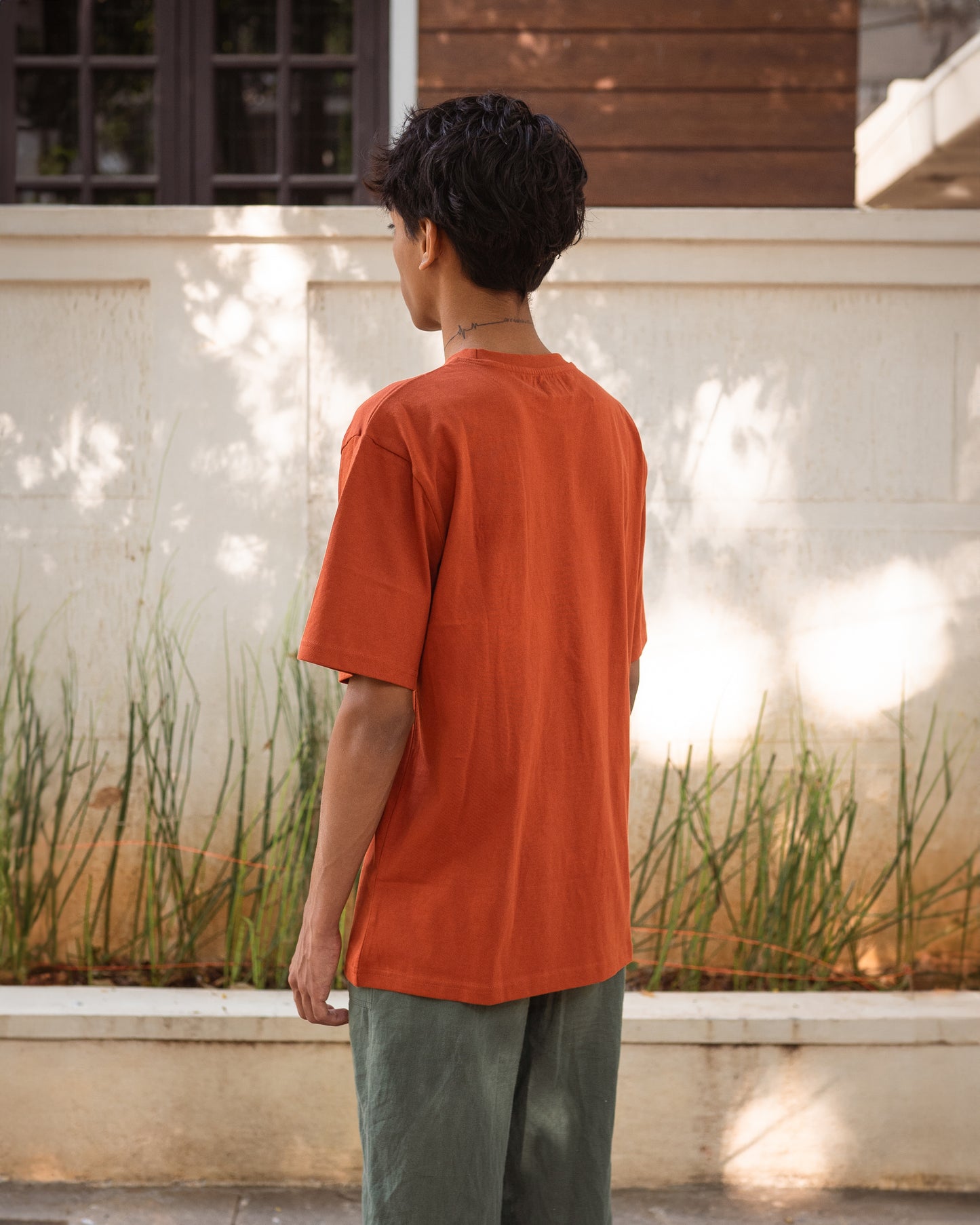 Back view of rust unisex t-shirt in breathable organic cotton
