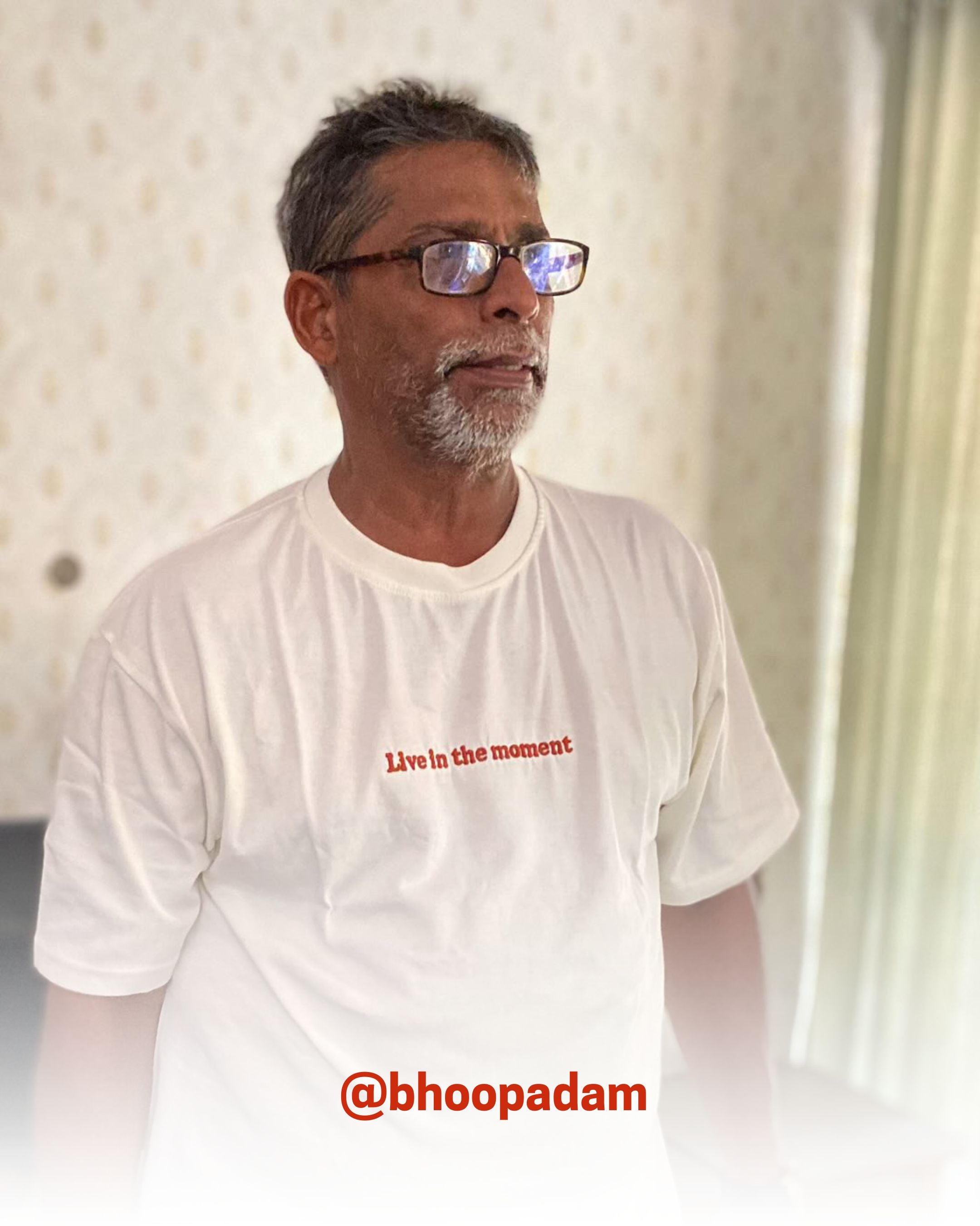 Older man wearing a white organic cotton T-Shirt indoors, showcasing 2512’s sustainable t-shirts, a customer favorite eco friendly tee.