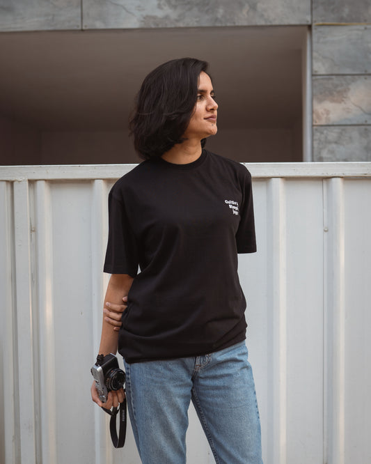 Model wearing rust organic cotton unisex t-shirt with “Mindful Living” embroidery, front view, relaxed fit