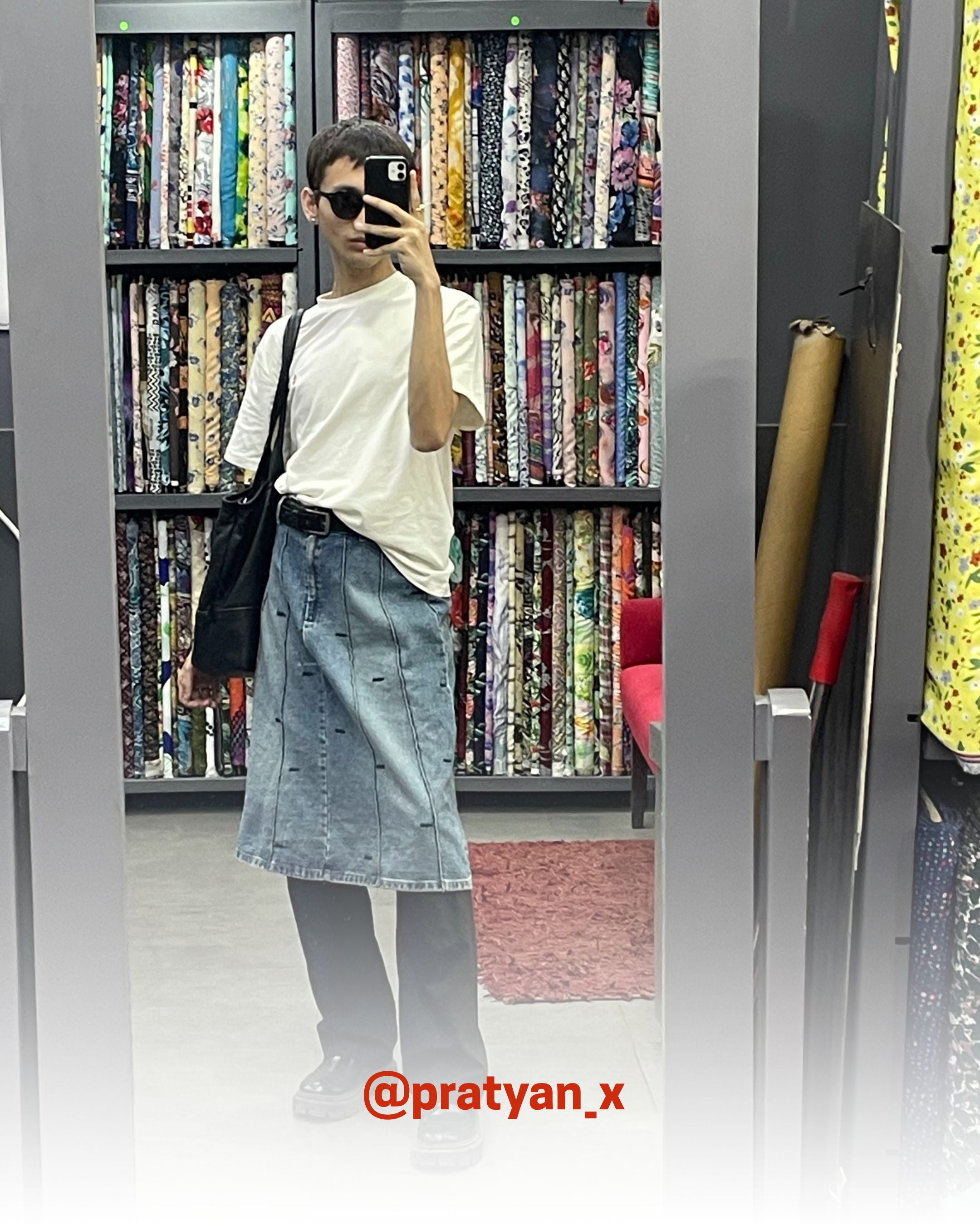Creator wearing a white organic cotton T-Shirt from 2512, styled with denim skirt and black tote, showcasing sustainable t-shirts and eco friendly fashion.