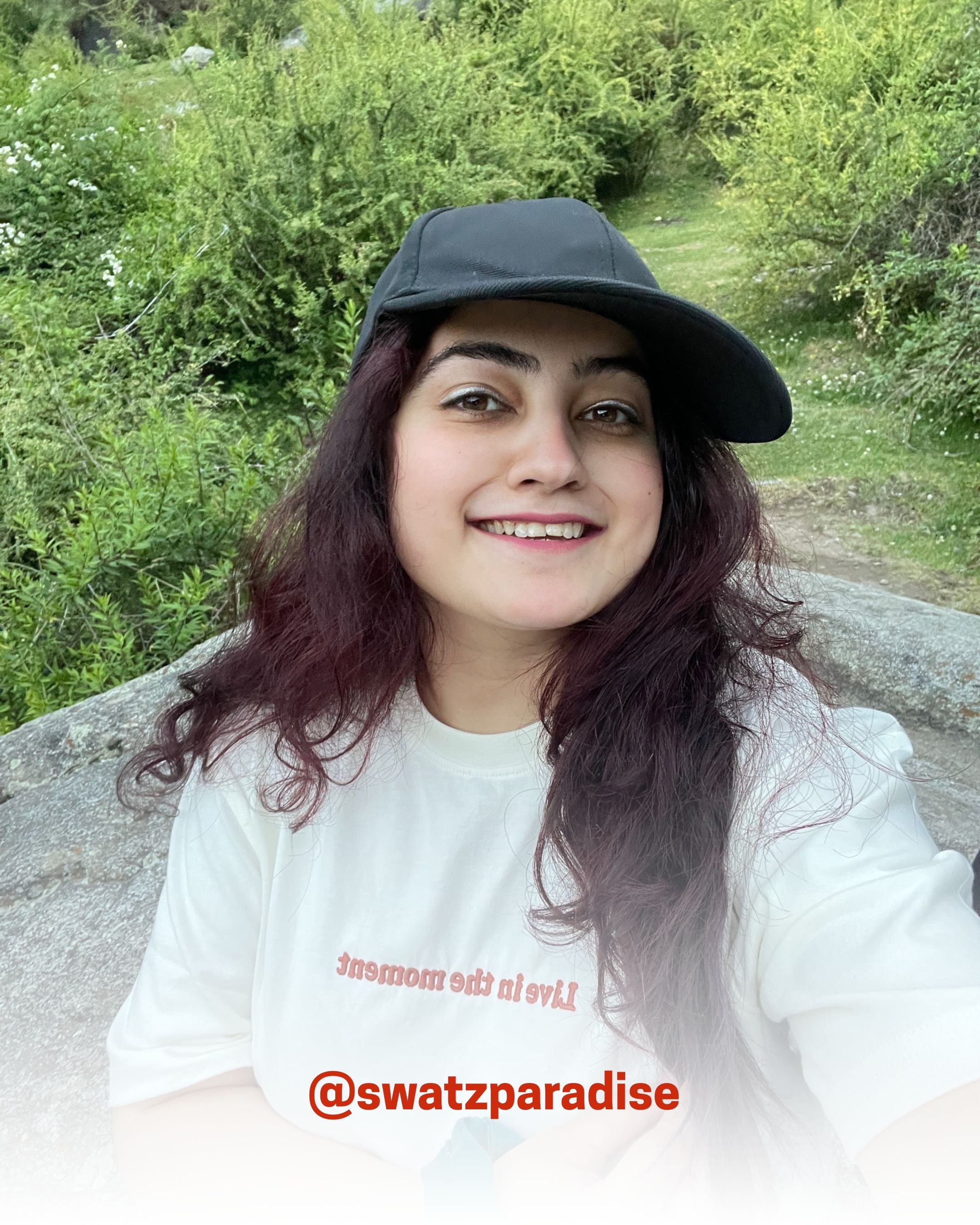 Smiling woman wearing a white organic cotton T-Shirt outdoors, showcasing 2512’s sustainable t-shirts, a customer favorite eco friendly tee.